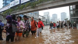 Authorities were working Friday to repair a dike that collapsed amid massive floods that have swamped the Indonesian capital as the waters gradually receded from the main streets of the teeming city.